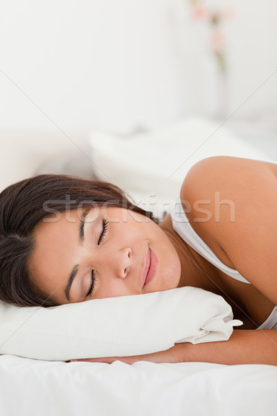 Stock photo: close up of a sleeping beautiful woman lying under sheet in bedroom