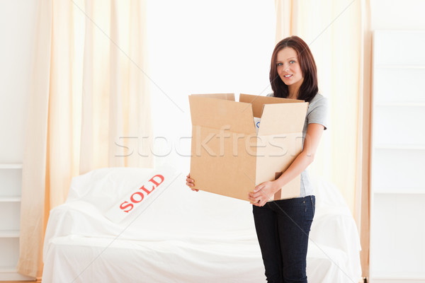 A woman is holding a full cardboard Stock photo © wavebreak_media