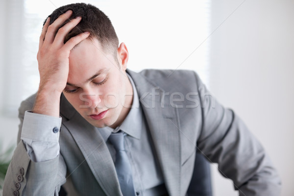 Close up of businessman after getting bad news sitting behind a table Stock photo © wavebreak_media