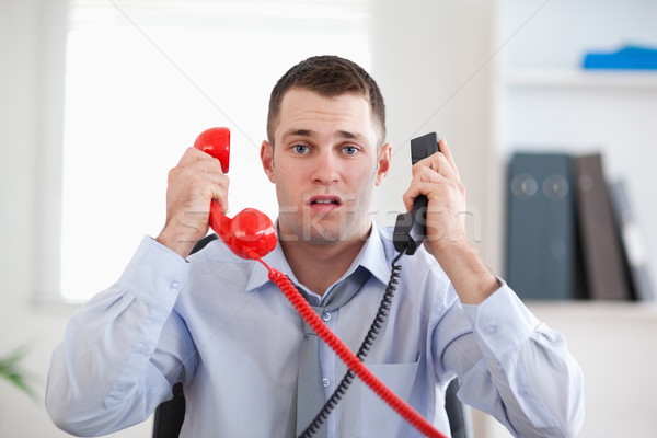 Stock photo: Businessman overextended with the telephone