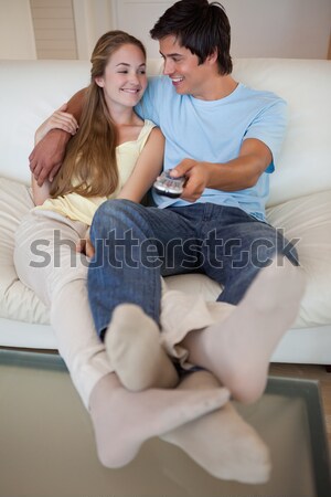 Portrait of a lovely couple watching television in their living room Stock photo © wavebreak_media