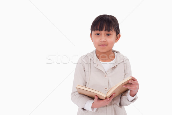 Young girl reading a book against a white background Stock photo © wavebreak_media