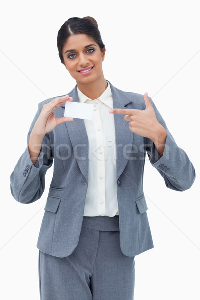 Saleswoman pointing at blank business card against a white background Stock photo © wavebreak_media