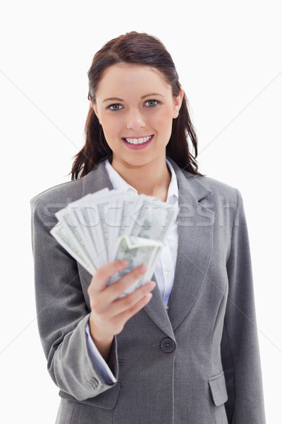 Close-up of a businesswoman smiling and holding a lot of dollar bank notes against white background Stock photo © wavebreak_media