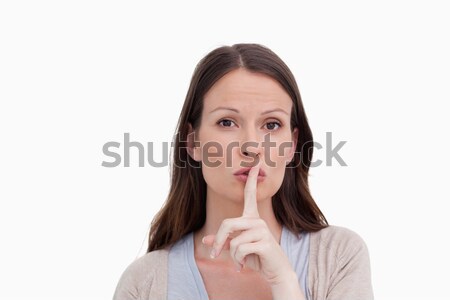Woman asking for silence against a white background Stock photo © wavebreak_media