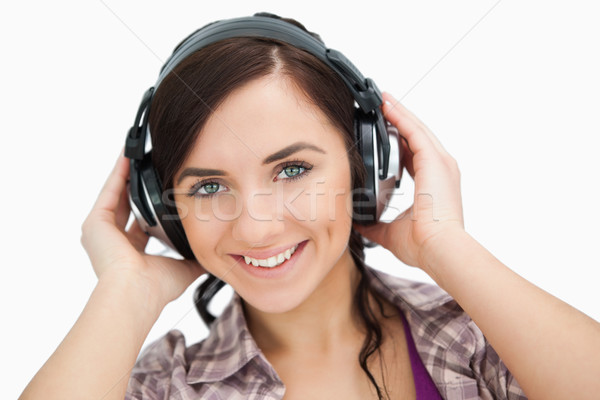 Blue eyed woman wearing headphones against white background Stock photo © wavebreak_media