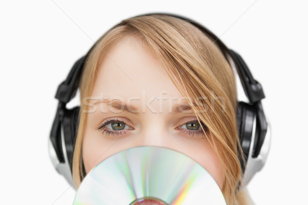 Close up of a woman with a cd in front of her face against a white background Stock photo © wavebreak_media