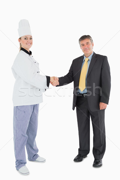 Portrait of businessman and female chef shaking hands  Stock photo © wavebreak_media