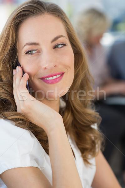 Beautiful businesswoman using mobile phone Stock photo © wavebreak_media