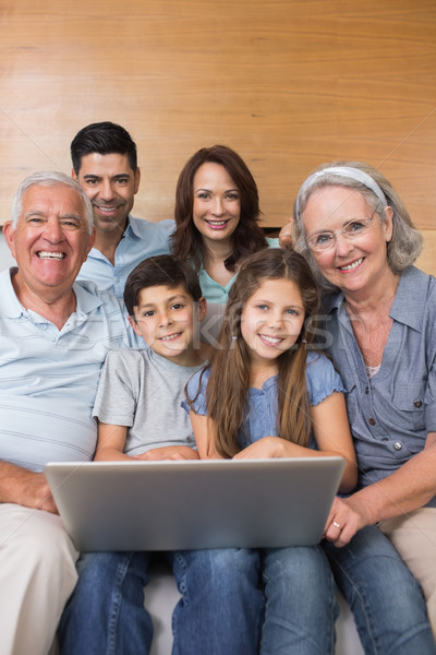 Extended family using laptop on sofa in living room Stock photo © wavebreak_media