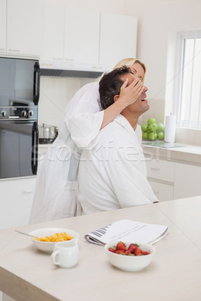 Woman covering mans eyes at breakfast table in kitchen Stock photo © wavebreak_media
