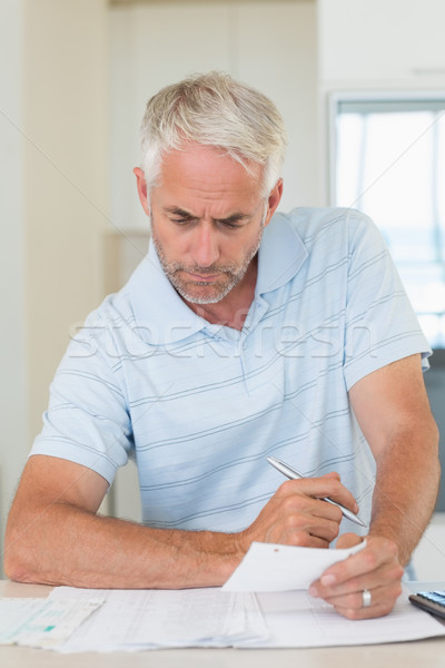 Stock photo: Focused man working out his finances