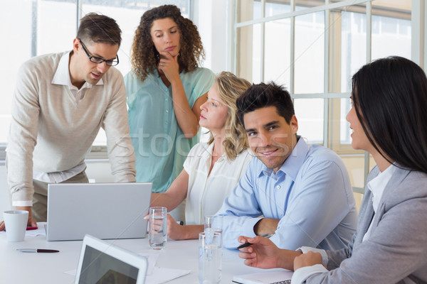 Casual business team having a meeting using laptop Stock photo © wavebreak_media