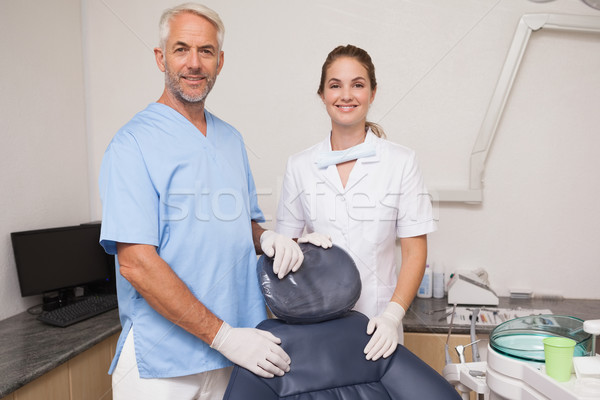 Dentist and assistant smiling at camera inviting you to the chai Stock photo © wavebreak_media