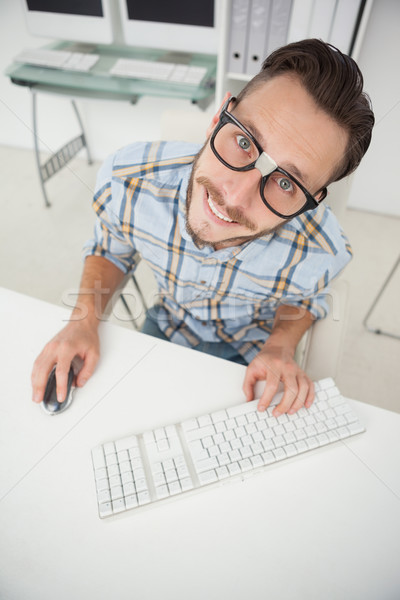 Nerdy businessman working on computer Stock photo © wavebreak_media