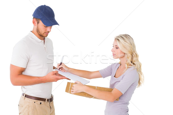 Happy delivery man giving package to customer Stock photo © wavebreak_media