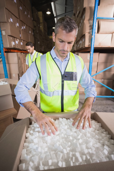 Warehouse worker in yellow vest preparing a shipment Stock photo © wavebreak_media