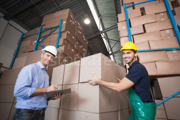 Warehouse worker loading up a pallet with manager Stock photo © wavebreak_media