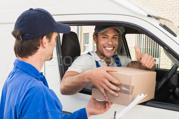 Delivery driver handing parcel to customer in his van Stock photo © wavebreak_media