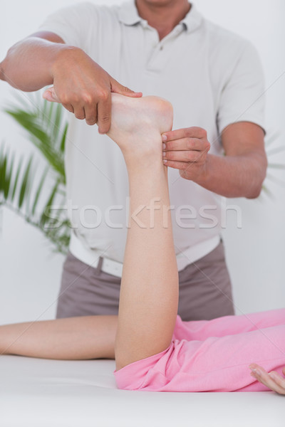 Stock photo: Physiotherapist doing leg massage to his patient