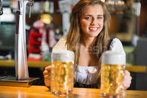 Stock photo: Smiling oktoberfest barmaid with beer