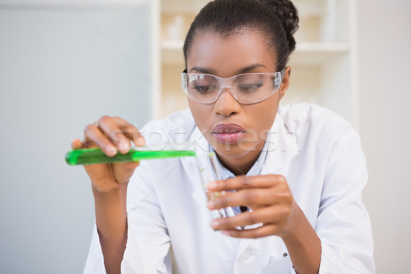 Concentrated scientist doing scientific experiment Stock photo © wavebreak_media