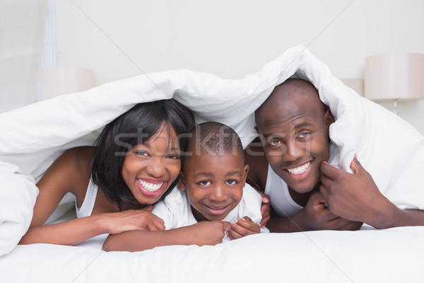 Portrait pretty couple with his son in bed together Stock photo © wavebreak_media