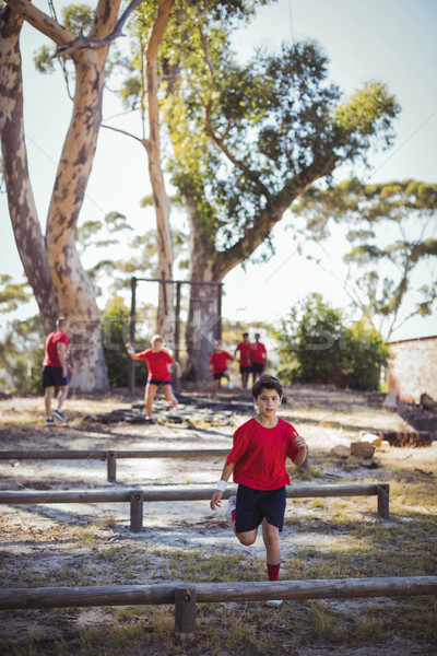 Trainer instructing kids during obstacle course training Stock photo © wavebreak_media