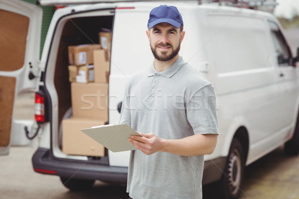 Delivery man writing on clipboard Stock photo © wavebreak_media
