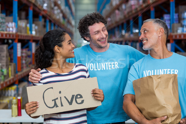 Stock photo: Happy colleagues holding sign boards with give message