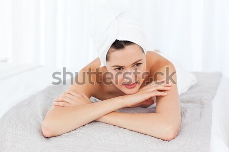 Smiling woman posing on her bed Stock photo © wavebreak_media