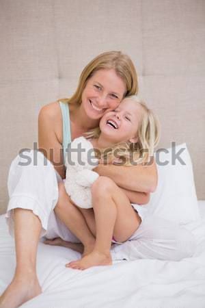 Portrait of a man kissing his girlfriend on the cheek under a duvet Stock photo © wavebreak_media