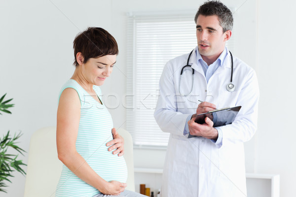 Pregnant woman visiting her doctor in a room Stock photo © wavebreak_media