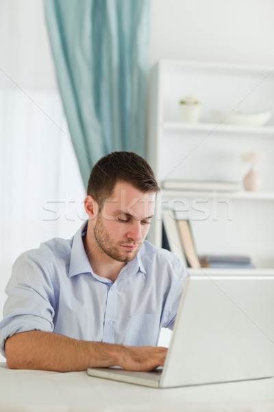 Fiatal üzletember tekert felfelé dolgozik laptop Stock fotó © wavebreak_media