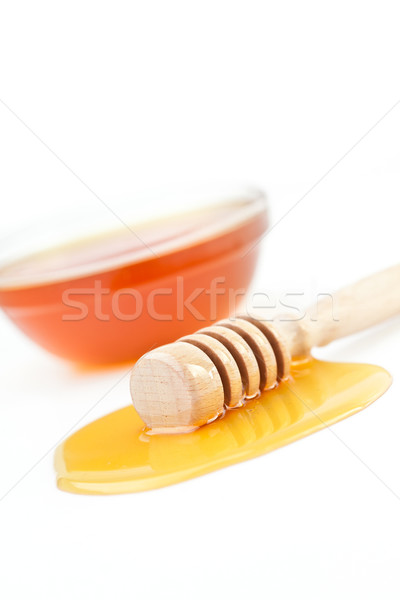 Honey dipper on the floor spilling honey in front of a honey bowl against a white background Stock photo © wavebreak_media