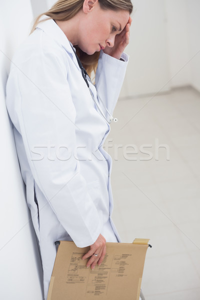 Stock photo: Doctor touching her forehead in hospital ward