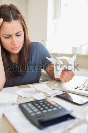 Woman calculating bills with laptop in ktichen Stock photo © wavebreak_media