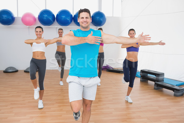 Smiling people doing power fitness exercise in fitness studio Stock photo © wavebreak_media