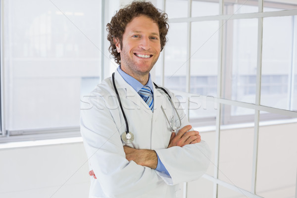 Male doctor standing with arms crossed in hospital Stock photo © wavebreak_media