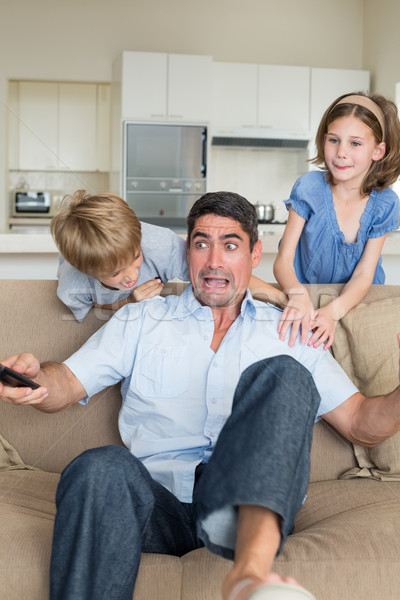 Enfants père espiègle canapé maison [[stock_photo]] © wavebreak_media