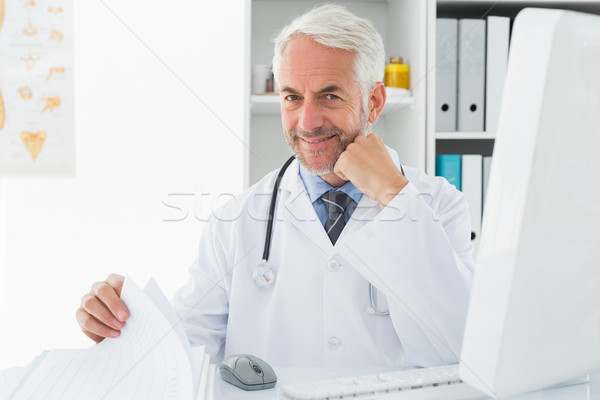 Mature male doctor with computer at medical office Stock photo © wavebreak_media