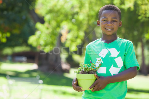 Young boy in recycling tshirt holding potted plant Stock photo © wavebreak_media