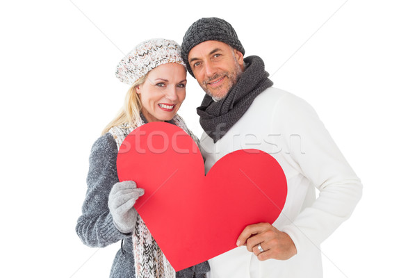 Smiling couple in winter fashion posing with heart shape Stock photo © wavebreak_media