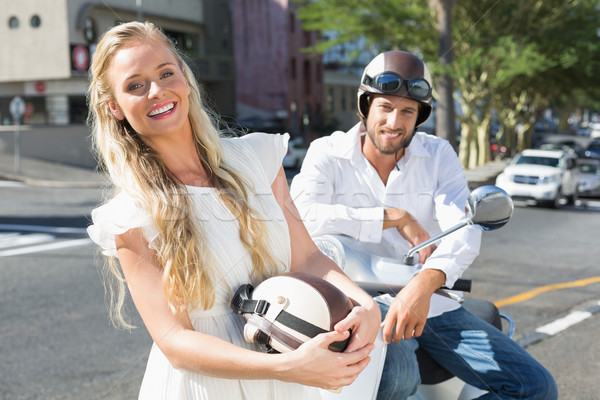 Stock photo: Attractive couple riding a scooter