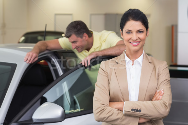 Stock photo: Smiling businesswoman standing with arms crossed
