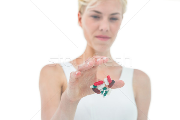 Blonde woman throwing away batch of pills Stock photo © wavebreak_media