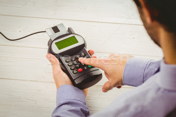 Man entering his pin on terminal Stock photo © wavebreak_media