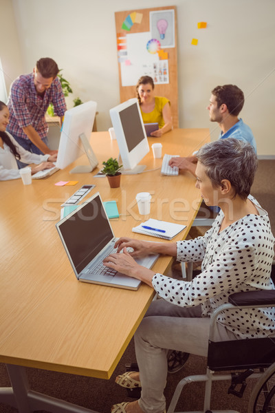 Stock photo: Creative casual businesswoman in wheelchair