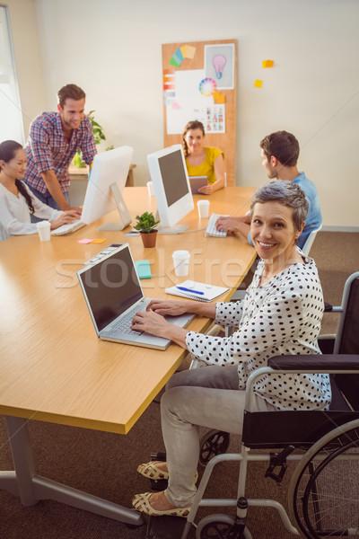 Creative casual businesswoman in wheelchair Stock photo © wavebreak_media