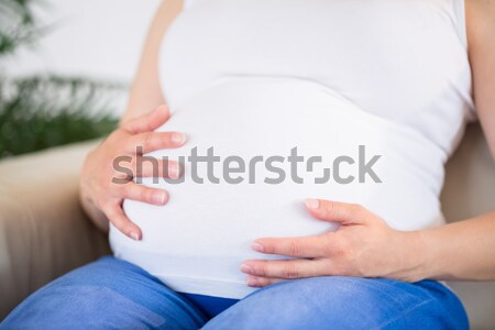 Hamile kadın eller göbek oturma kanepe Stok fotoğraf © wavebreak_media